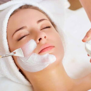 A licensed aesthetician applies a treatment mask during a SkinCeuticals acne facial at HS MedSpa in Tysons, VA