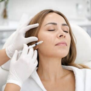 A licensed medical professional administers a Sculptra injection in the cheek at HS MedSpa in Tysons, VA